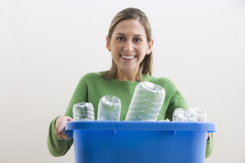 Person filling a skip with construction waste