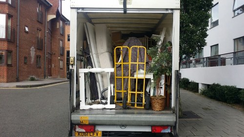 Removal team loading a van in front of a London flat showing man and van service