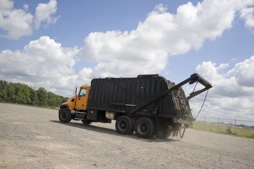 Skip truck removing waste from site